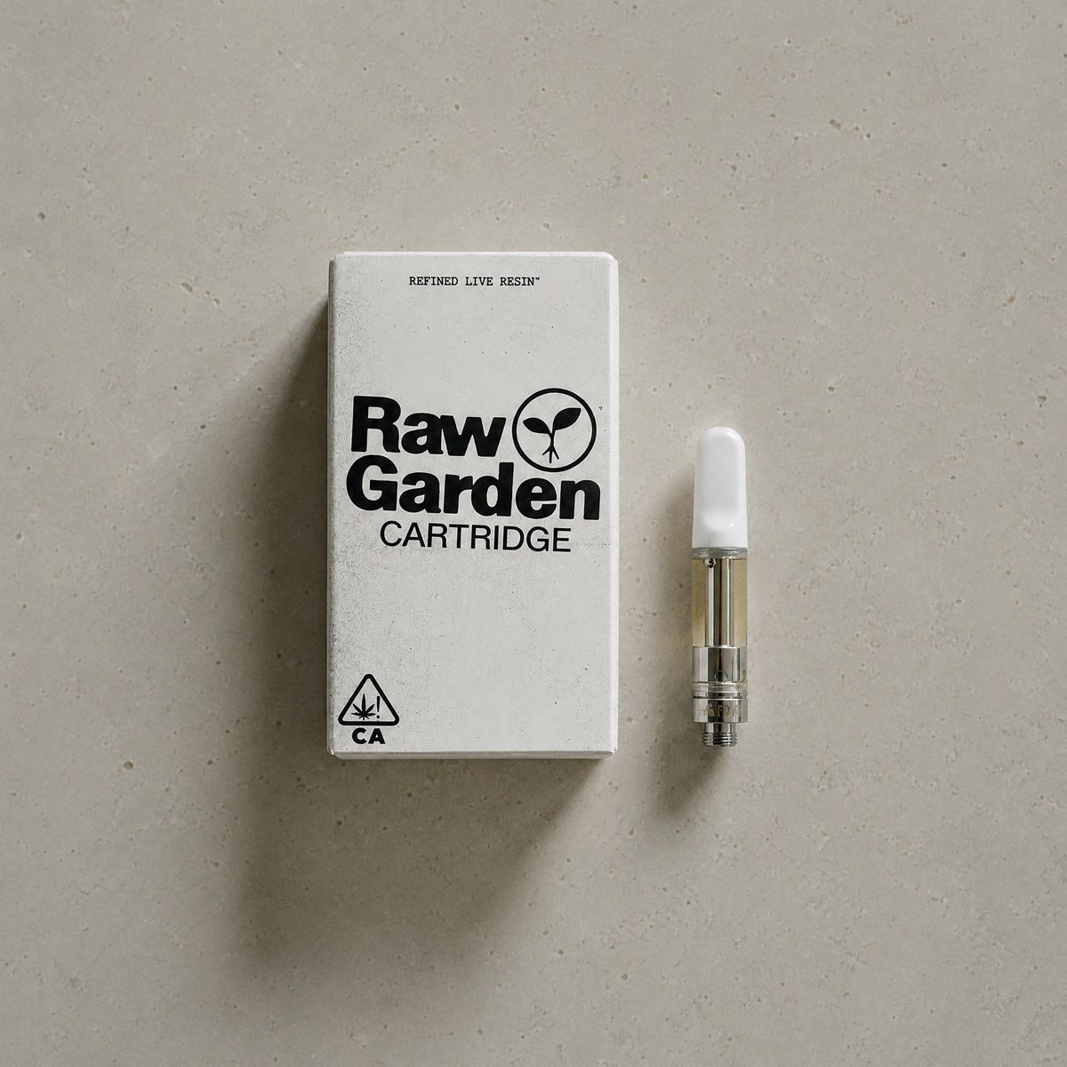Raw Garden Beary White refined live resin cartridge and box on pale limestone, seen from above
